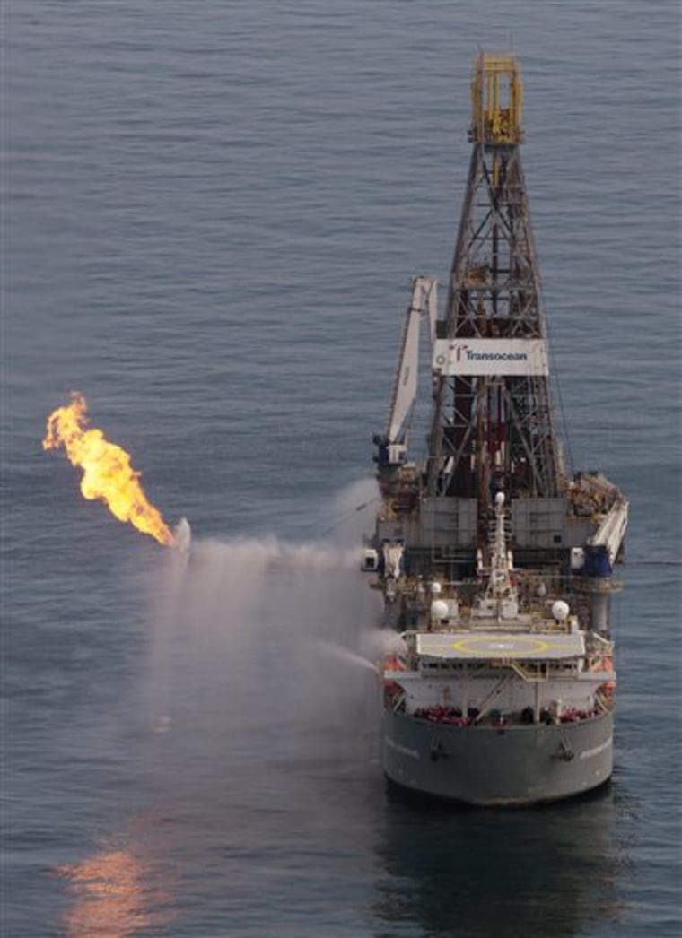 The Transocean Deepwater Discoverer drilling rig operates over the site of the Deepwater Horizon oil spill in the Gulf of Mexico Sunday, June 13, 2010. Oil continues to flow from the wellhead some 5,000 feet below the surface.  (AP Photo/Dave Martin)